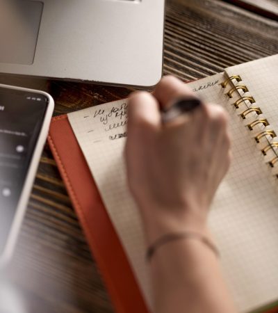 top-view-freelance-woman-taking-notes